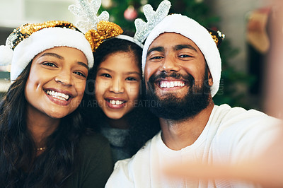 Buy stock photo Family, Christmas selfie and festive holiday celebration, portrait and face in home, hat and decoration together. Mother, father and girl with picture for social media, xmas event and hat in house