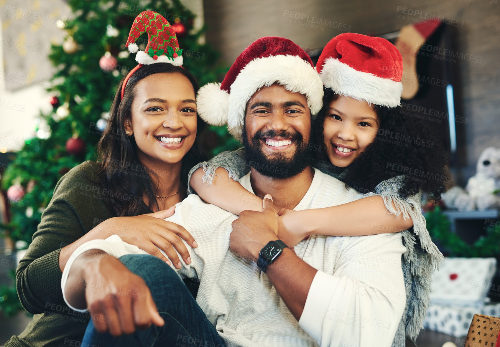 Buy stock photo Christmas, happy and portrait of family in living room for celebration, affection and festive. Holiday, smile and bonding with girl hug parents at home for content, gratitude and xmas vacation 