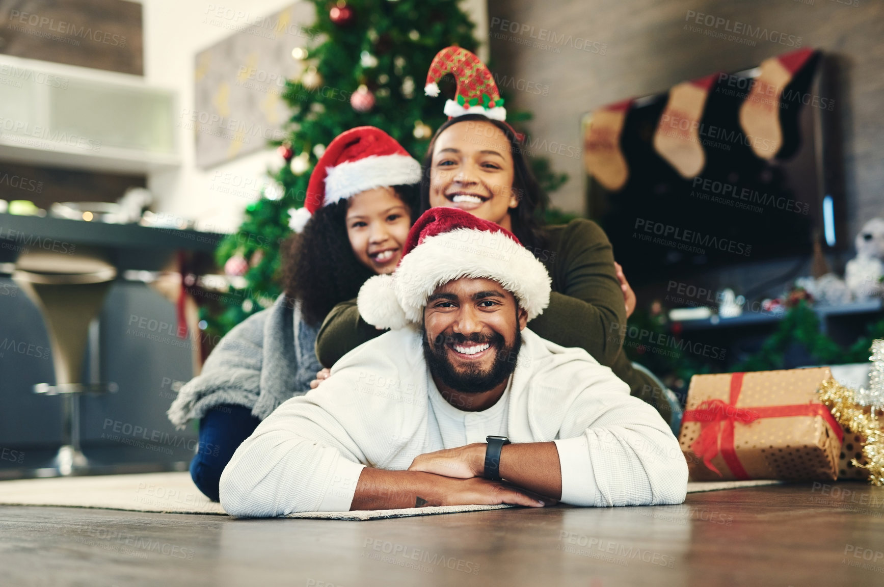 Buy stock photo Family, christmas and love with child, father and mother together on lounge floor to celebrate Christian holiday happiness, care and support. Portrait of man, woman and girl daughter in Brazil home