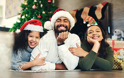 Buy stock photo Christmas, portrait and family, kids and parents in lounge, winter celebration and love, care and happiness together. Happy family, girl and child celebrate festive holiday, santa hats or living room