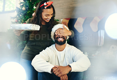 Buy stock photo Christmas, bonding couple and surprise gift in house or home living room for holiday celebration, love or festive vacation. Smile, happy or xmas woman with present box in morning secret santa for man