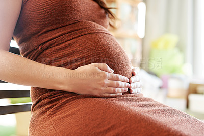 Buy stock photo Shot of a mother to be caressing her baby bump