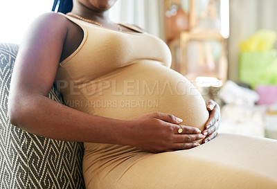 Buy stock photo Shot of a mother to be caressing her baby bump