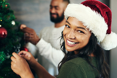 Buy stock photo Couple, portrait and christmas tree decor together with love and care during the festive season. Husband, wife and hanging ornaments on an xmas tree while decorating with tinsel and bauble