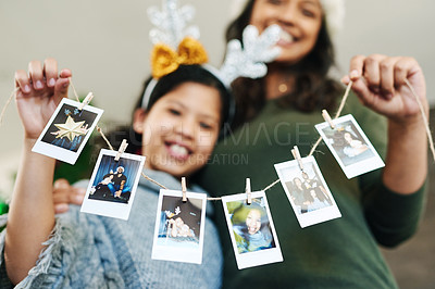 Buy stock photo Mother, child and christmas photo garland for family tree decoration for holiday celebration, love and happiness. Woman and girl or daughter in house with photograph or pictures memory banner