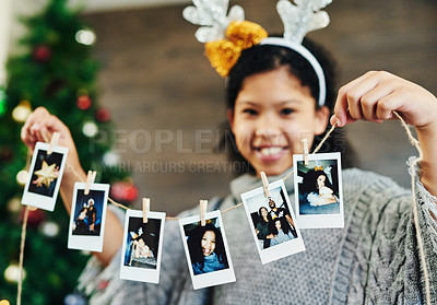 Buy stock photo Girl portrait, polaroid and christmas celebration, happy smile and memories, photograph and decoration in home. Child, picture and string for xmas, celebrate and festive holiday, happiness and kid
