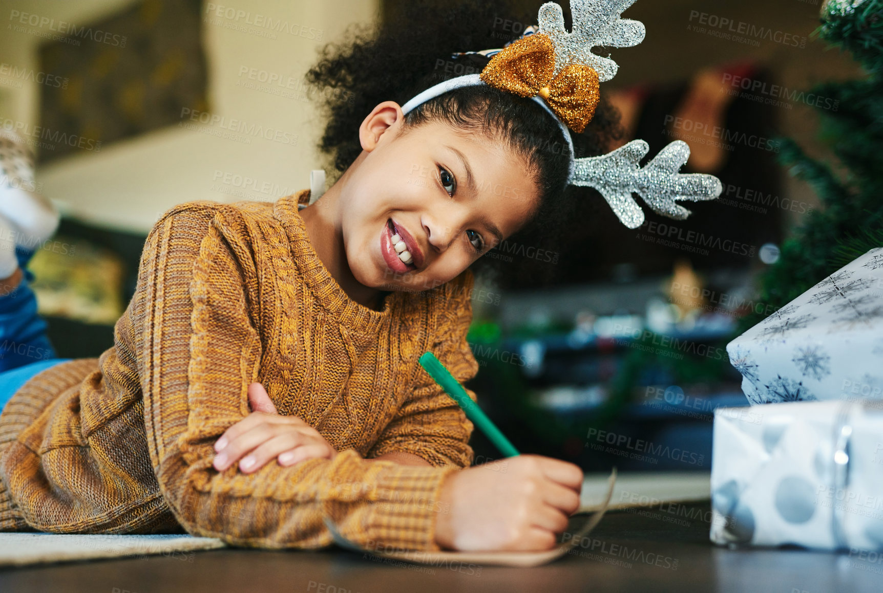 Buy stock photo Christmas, happiness and girl writing a list to Santa Claus for present, gifts and toys for holiday tradition. Festival, celebration and face portrait of child on floor to write letter in family home