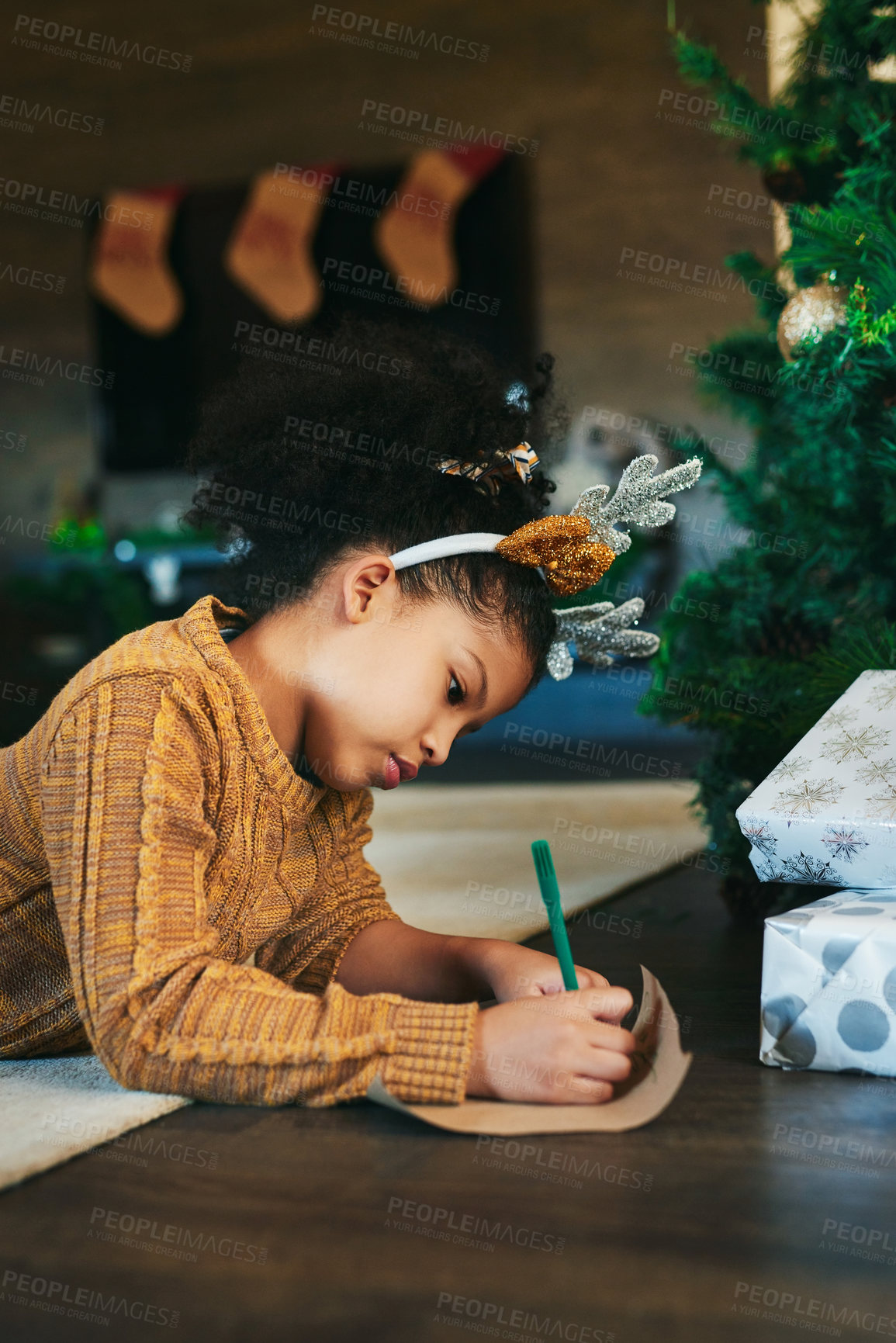Buy stock photo Christmas, celebrate and girl writing in a card, list or letter for holiday on the living room floor. Idea, wish and child with paper for a gift, note or drawing during xmas celebration in a house