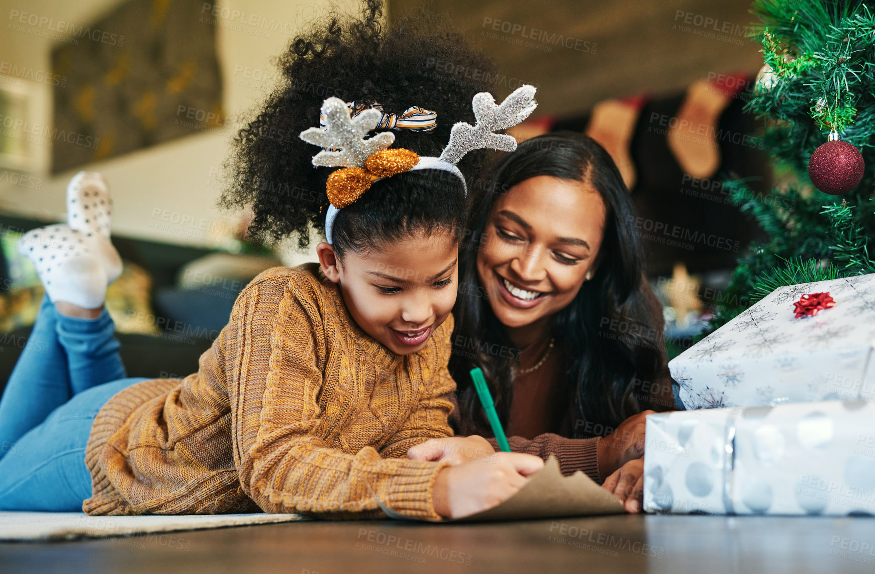 Buy stock photo Christmas, family and writing with a mother and daughter sending a message or gift wish list to santa. Kids, love and happy with a woman and girl child lying on the living room of their home together