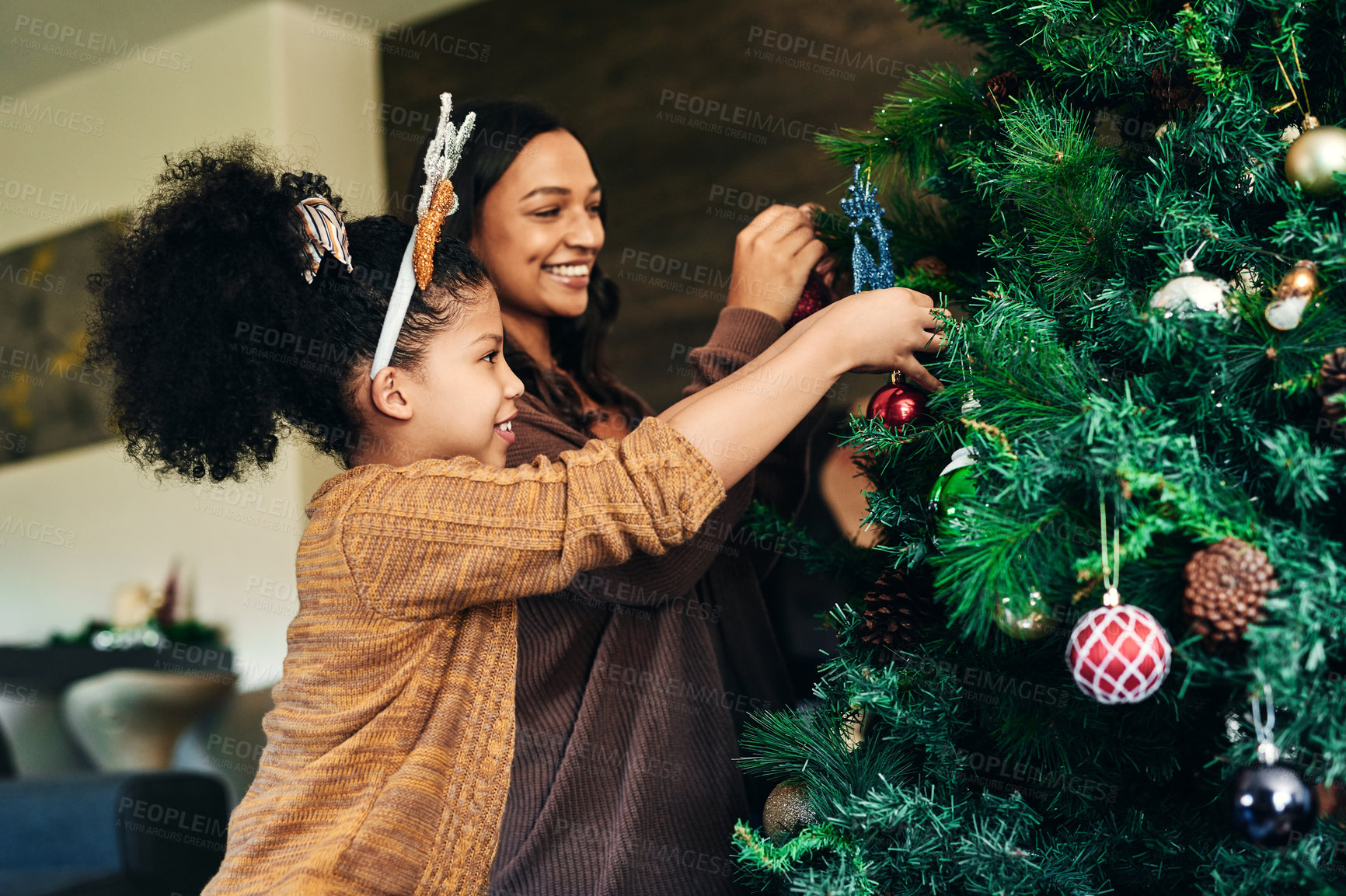 Buy stock photo Mother, girl and bonding with christmas tree decoration in family home or house for celebration event, festive holiday or vacation. Smile, happy or xmas woman and child hanging lights, balls or decor