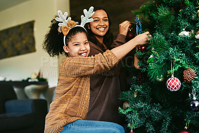 Buy stock photo Christmas tree decoration, family and girl with mother helping in home living room. Portrait, festive season and happy child with mom decorating with ornaments and preparing for xmas party in house.