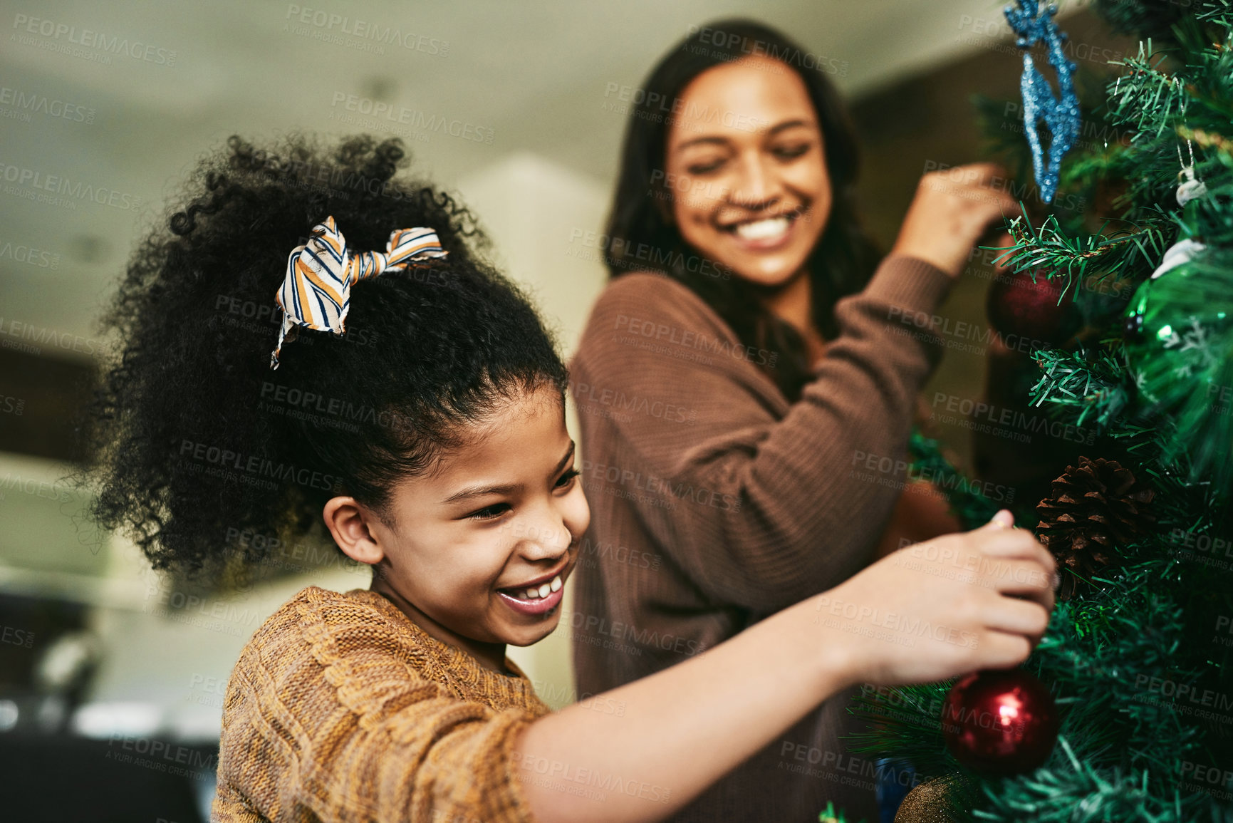 Buy stock photo Mother, girl or bonding in christmas tree decorating in house or home living room for festive holiday, celebration or vacation. Smile, happy or xmas child and mom or kid and woman in light decoration