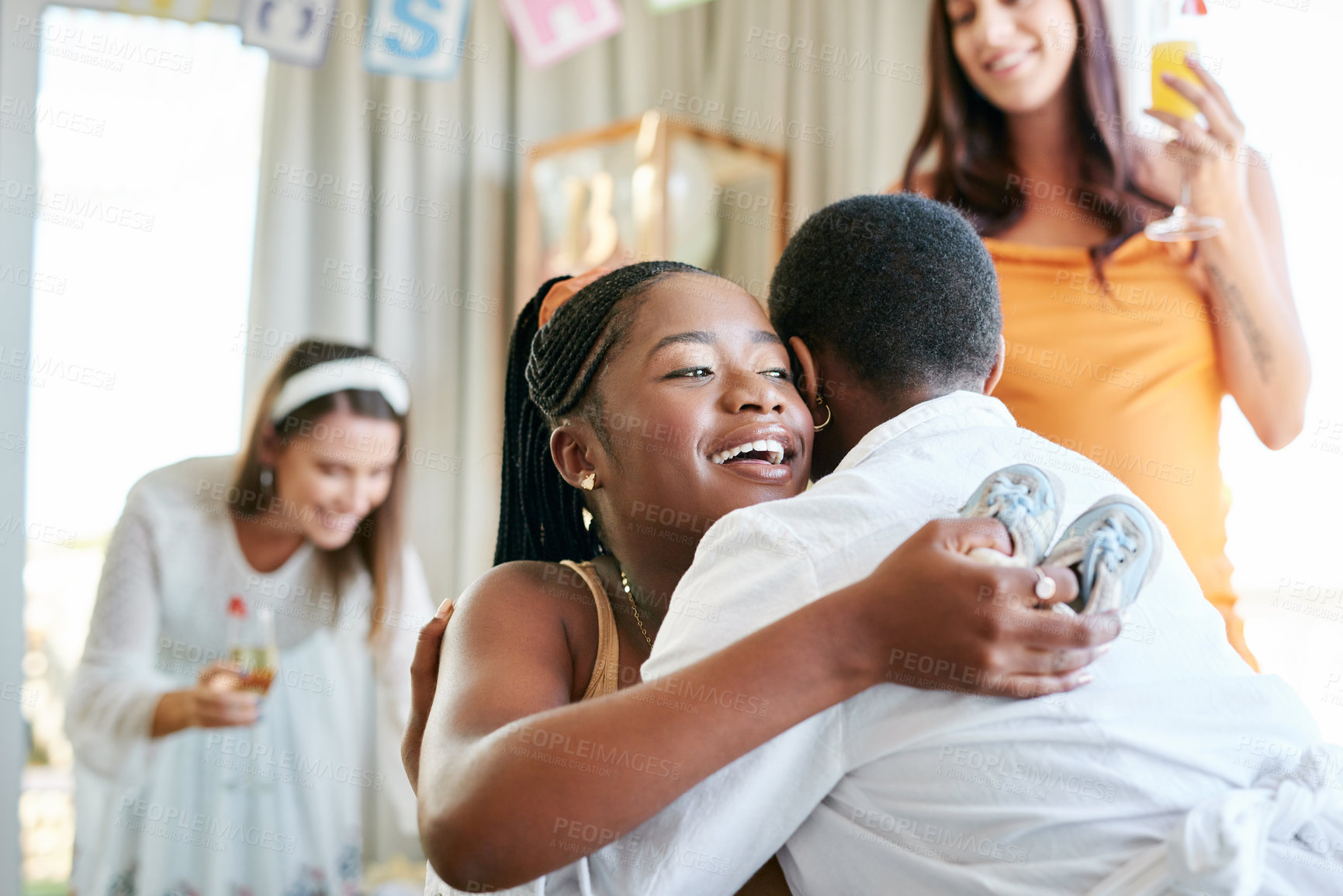 Buy stock photo Shot of a young mother to be hugging her friend for a gift given at her baby shower