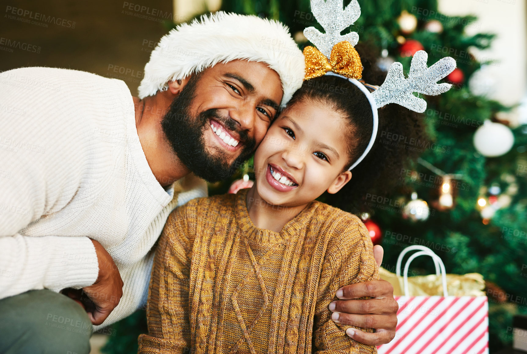Buy stock photo Chirtsmas, family and love with a father giving child a hug for happiness and care while together to celebrate Christian religion holiday. Portrait, smile and support of man for girl daughter at home