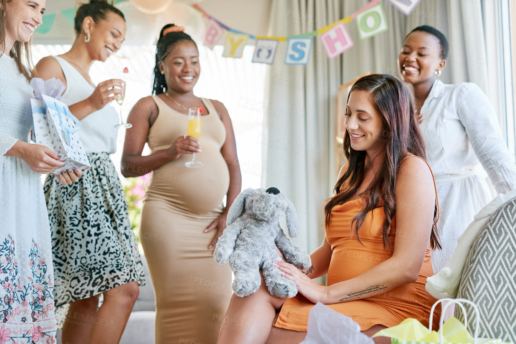 Buy stock photo Shot of a pregnant mother to be receiving gifts from her friends at her baby shower