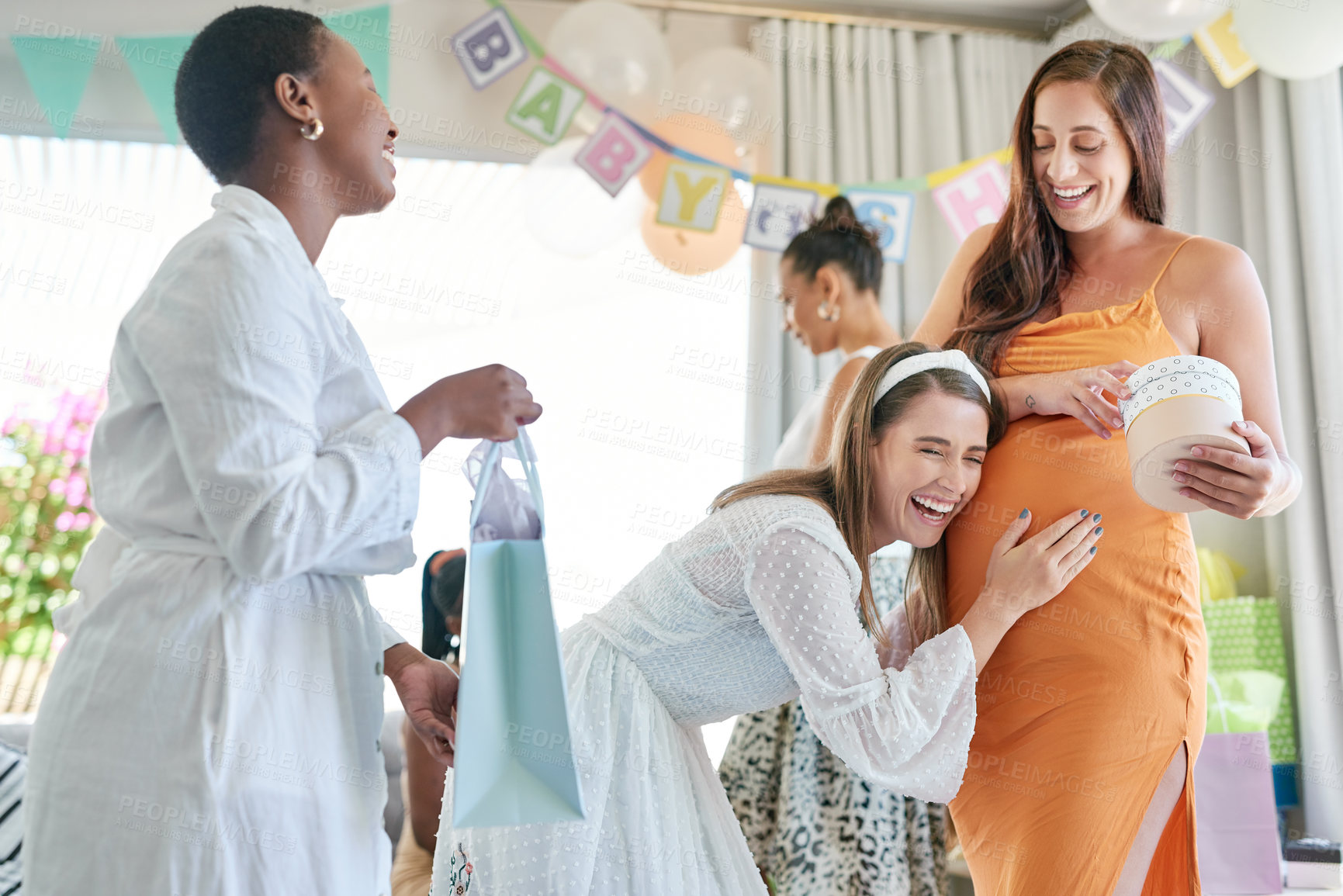 Buy stock photo Shot of a pregnant mother to be receiving gifts from her friends at her baby shower