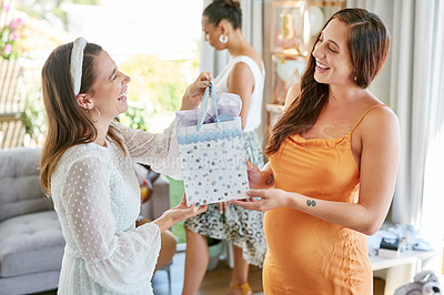 Buy stock photo Shot of a pregnant mother to be receiving gifts from her friends at her baby shower