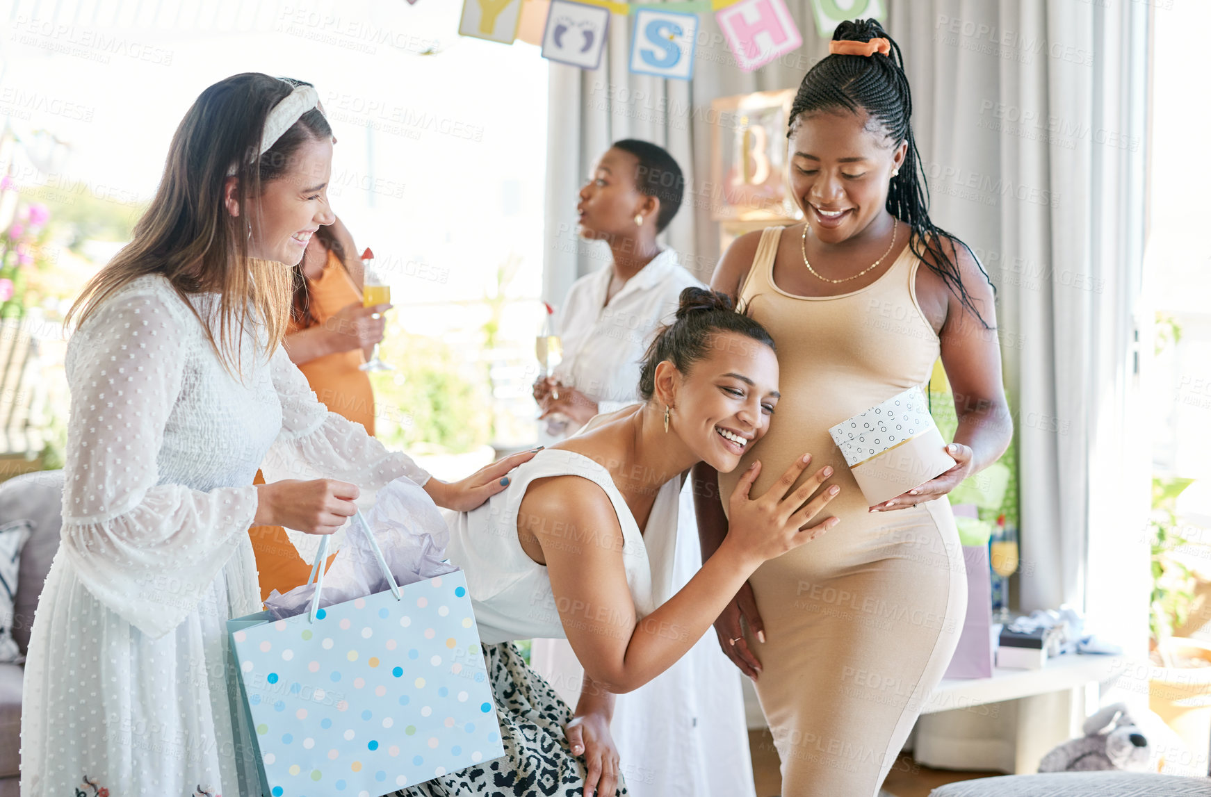 Buy stock photo Shot of a pregnant mother to be receiving gifts from her friends at her baby shower