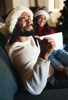 Buy stock photo Portrait, home and man with thumbs up on Christmas in celebration of a Christian holiday with wife at home. Love, smile and happy person enjoys a special family day on sofa in winter in New Zealand