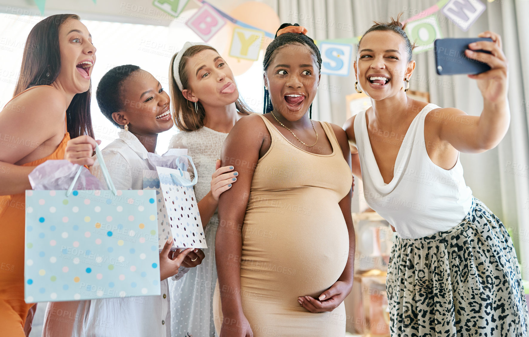 Buy stock photo Shot of a group of female friends taking selfies at a baby shower