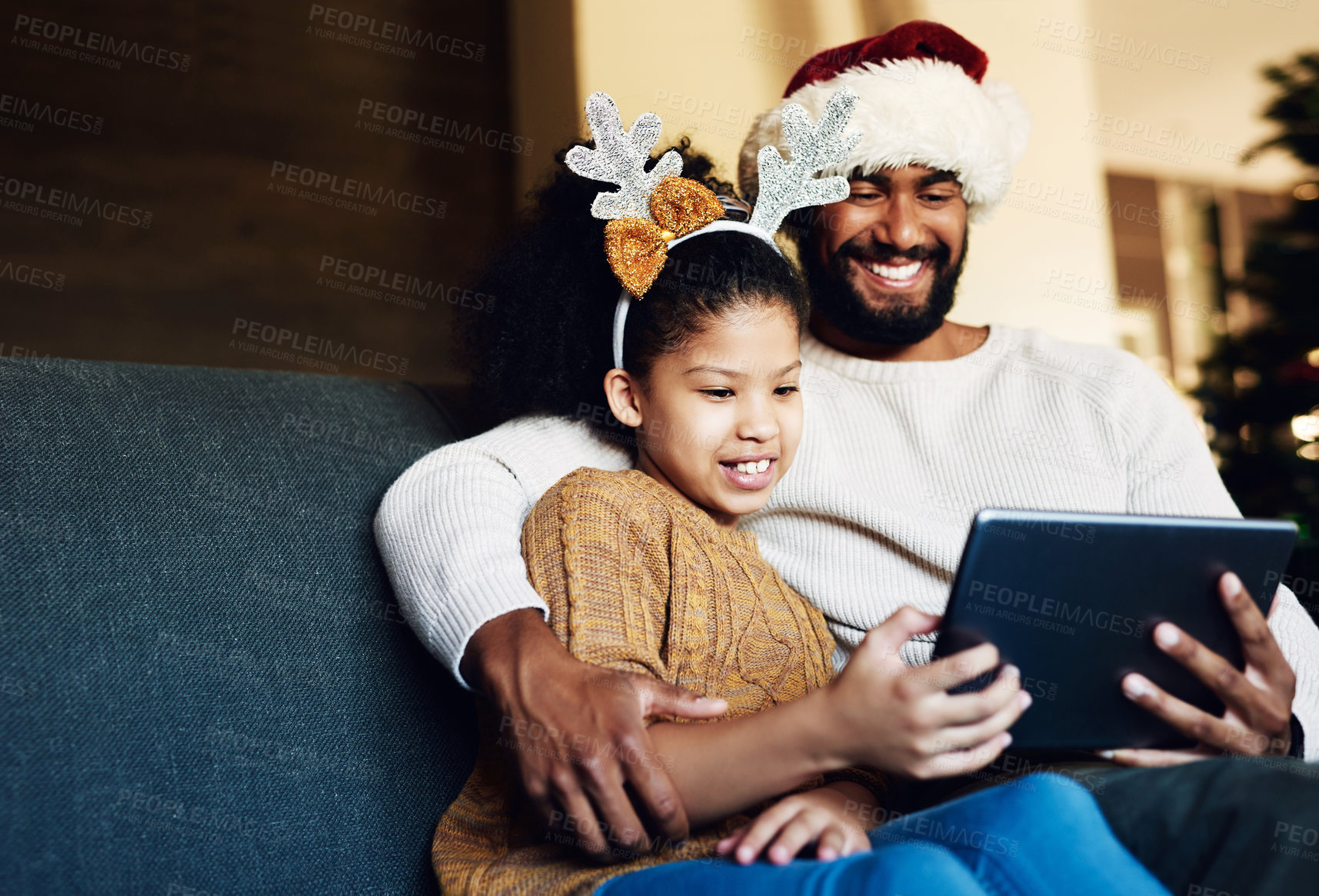 Buy stock photo Family Christmas, tablet and girl with father on sofa in living room streaming video, movie or web browsing. Love, xmas and kid with dad on digital touchscreen bonding, caring and enjoying holiday.