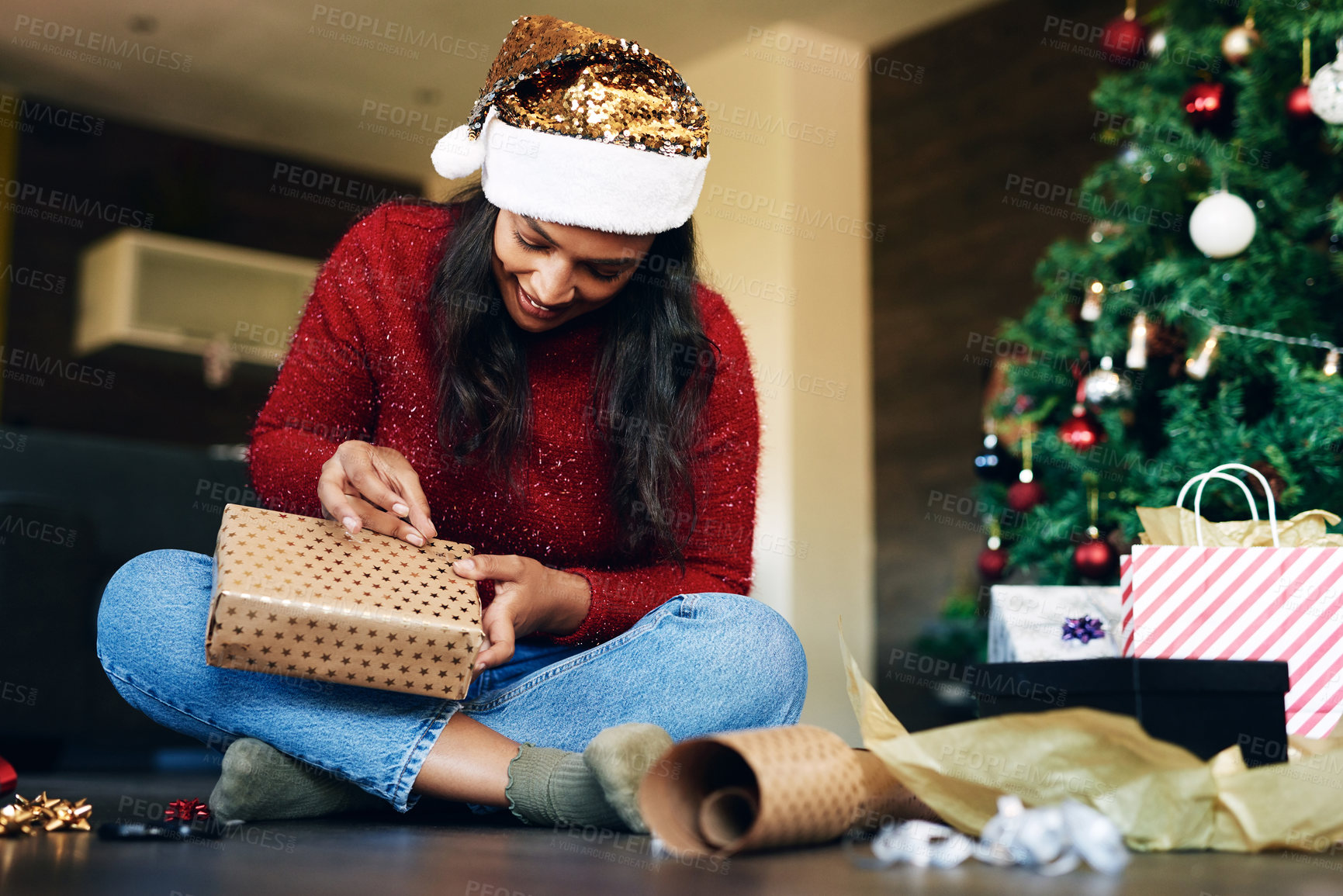 Buy stock photo Woman, Christmas and gift wrapping by the tree for festive season, holiday or special surprise at home. Happy excited female busy with gifting wrap, box or present for December celebration indoors