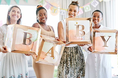 Buy stock photo Shot of a group of women holding a sign at a friends baby shower