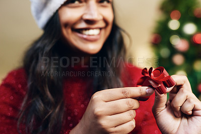 Buy stock photo Christmas, ribbon and woman wrapping gifts for a holiday party, event or dinner at home. Happy, excited and girl with a smile holding bow for festive decoration for xmas celebration presents at house