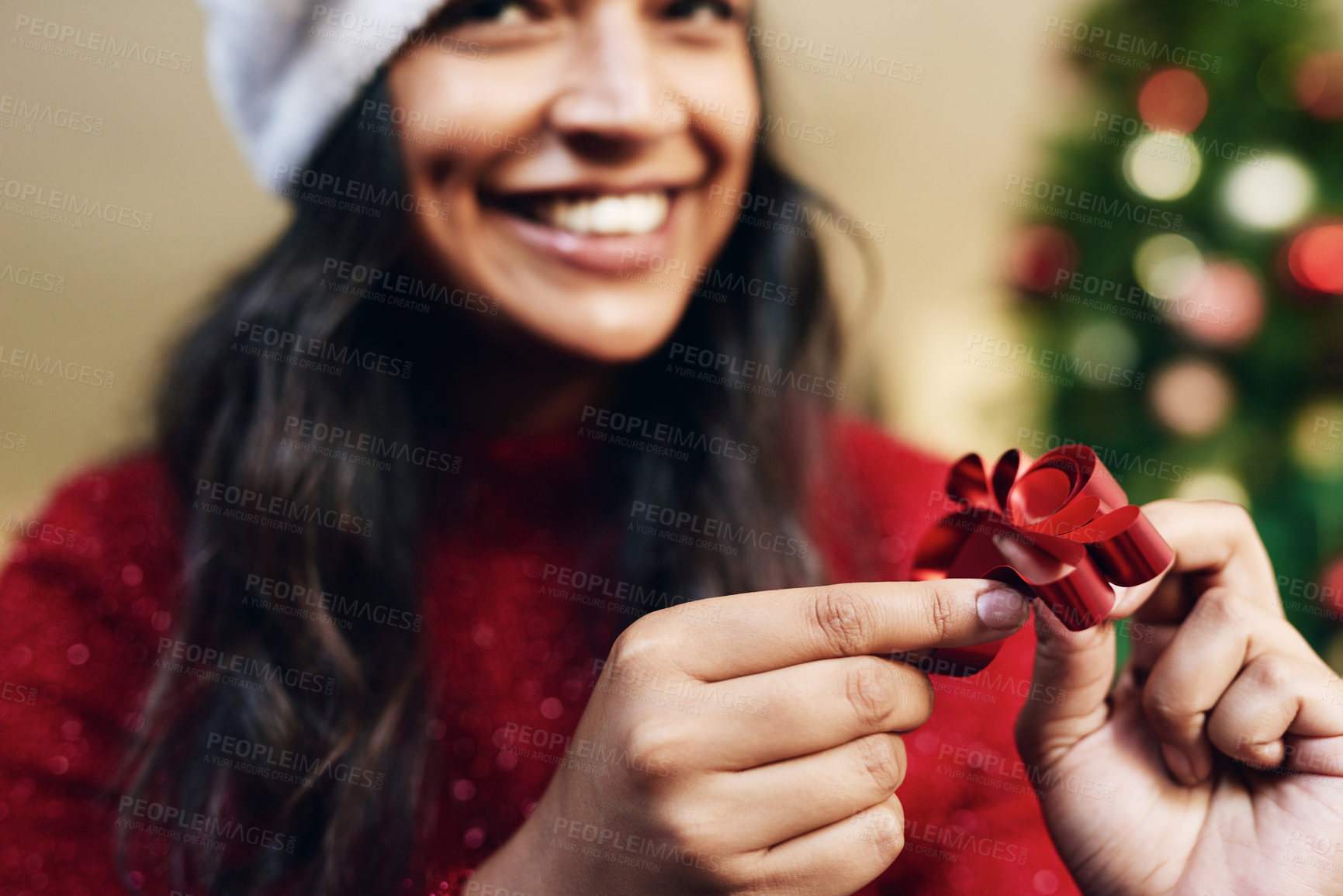 Buy stock photo Christmas, ribbon and woman wrapping gifts for a holiday party, event or dinner at home. Happy, excited and girl with a smile holding bow for festive decoration for xmas celebration presents at house