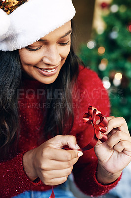 Buy stock photo Woman, happy and tie christmas ribbon, relax at home for holidays present or gift. Bow, black woman smile and festive celebration bow for xmas, christmas tree decroation and happiness for vacation