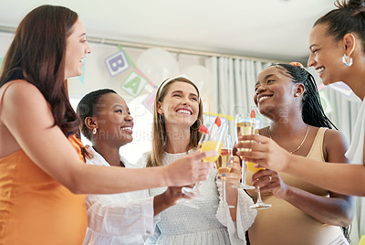 Buy stock photo Shot of a group of female friends toasting to their pregnant friend at a baby shower