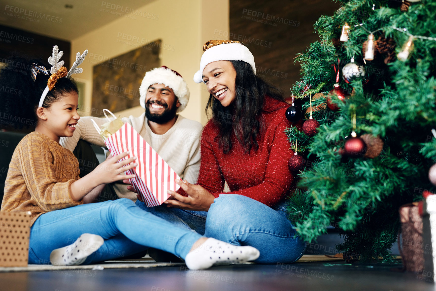 Buy stock photo Family, christmas celebration and gift giving, happy smile and love on floor in home, festive holiday and surprise, Girl, mother and father celebrate xmas with present, happiness and bag in house