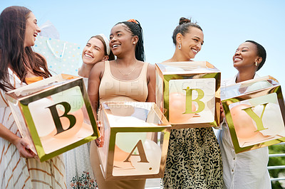 Buy stock photo Shot of a group of women holding a sign at a friends baby shower