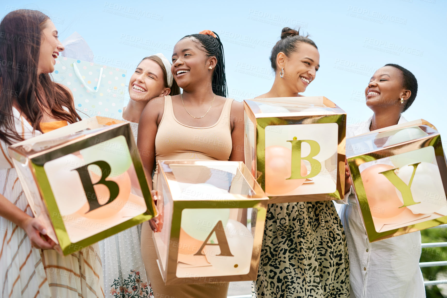 Buy stock photo Shot of a group of women holding a sign at a friends baby shower