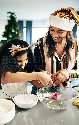Buy stock photo Black woman, girl and christmas baking in kitchen for learning, teaching and domestic skills in family home. Cooking, mother and daughter in house for holiday cookies, festive food and celebration