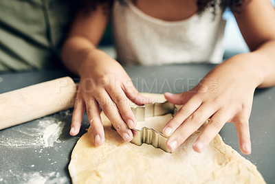 Buy stock photo Family, hands baking and christmas tree cookies being made with a cutter while bonding and learning. Sweets, dessert and biscuit treat being baked with dough by a child and her parent at xmas