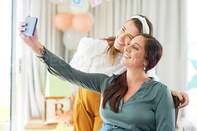 Buy stock photo Shot of a group of female friends taking selfies at a baby shower