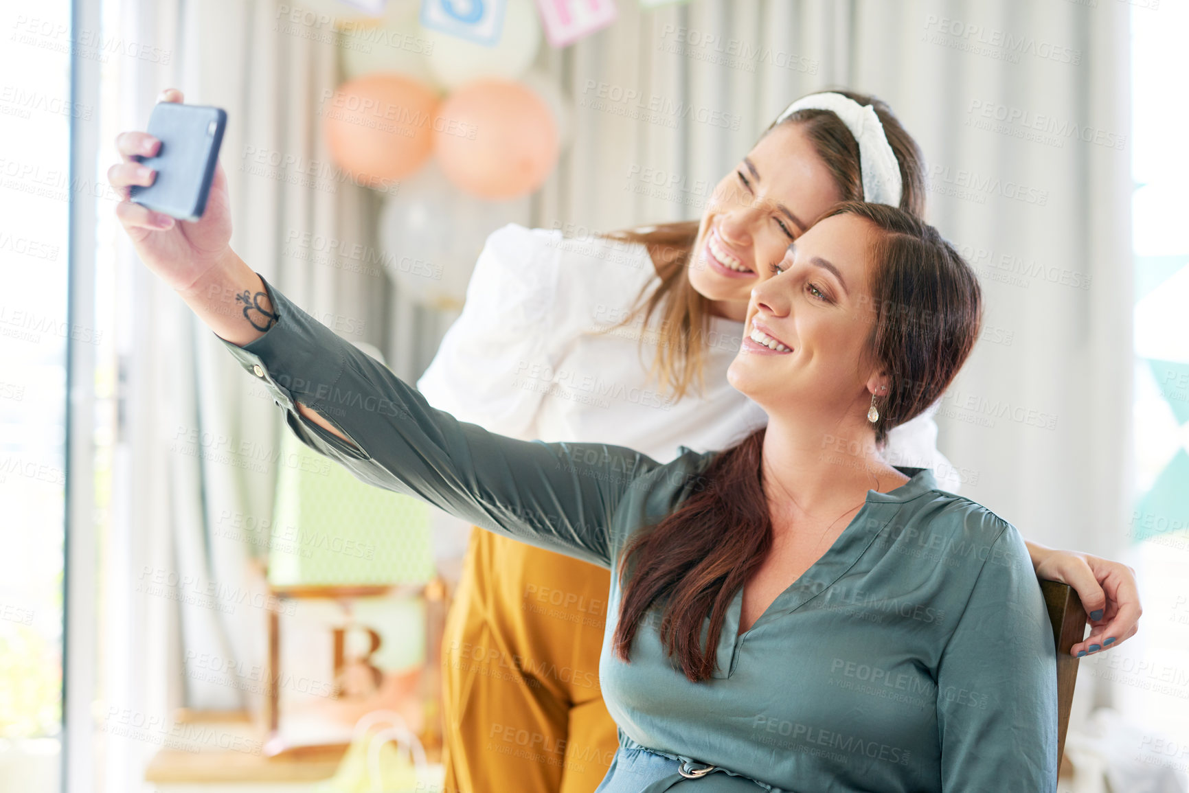 Buy stock photo Shot of a group of female friends taking selfies at a baby shower