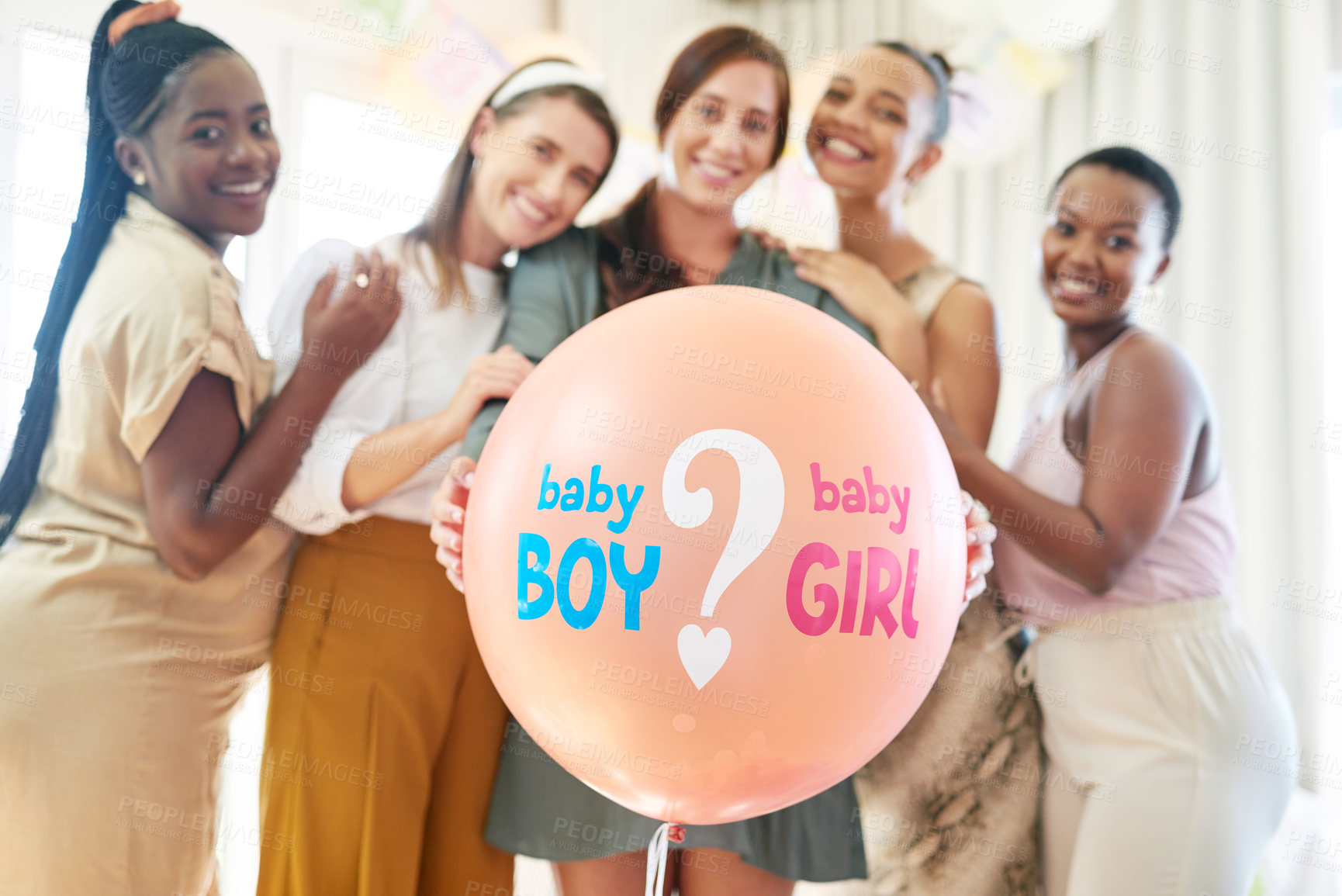 Buy stock photo Shot of a group of women about to pop a balloon for a gender reveal during a baby shower