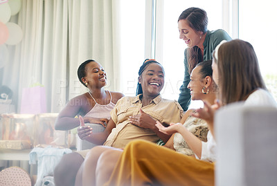 Buy stock photo Shot of a group of friends relaxing together during a baby shower