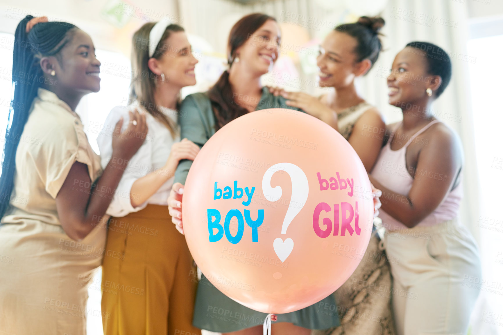 Buy stock photo Shot of a group of women about to pop a balloon for a gender reveal during a baby shower