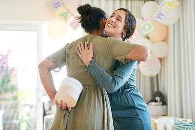 Buy stock photo Shot of a woman about to give her friend a gift at her baby shower