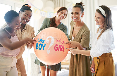 Buy stock photo Shot of a group of women about to pop a balloon for a gender reveal during a baby shower