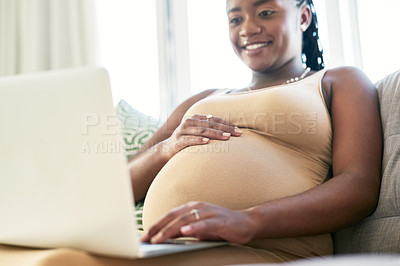 Buy stock photo Shot of a young mother to be working from home