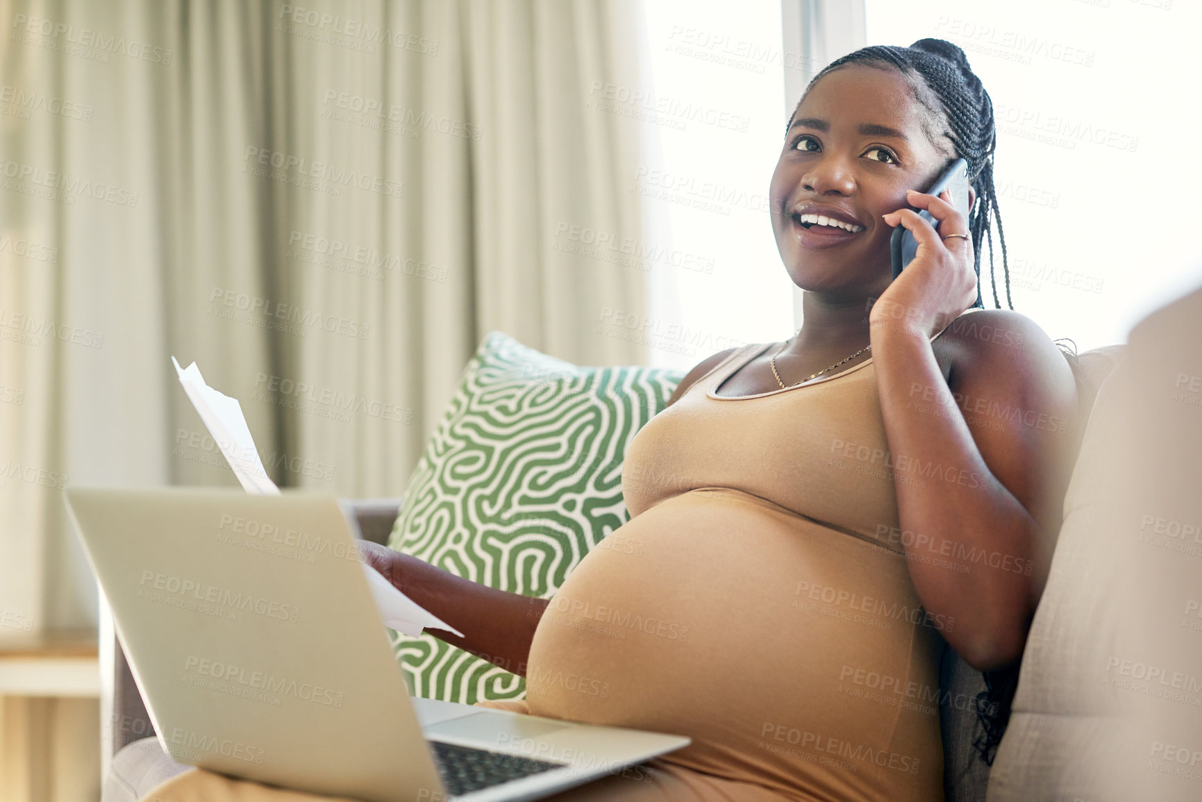 Buy stock photo Shot of a young mother to be working from home using her smartphone