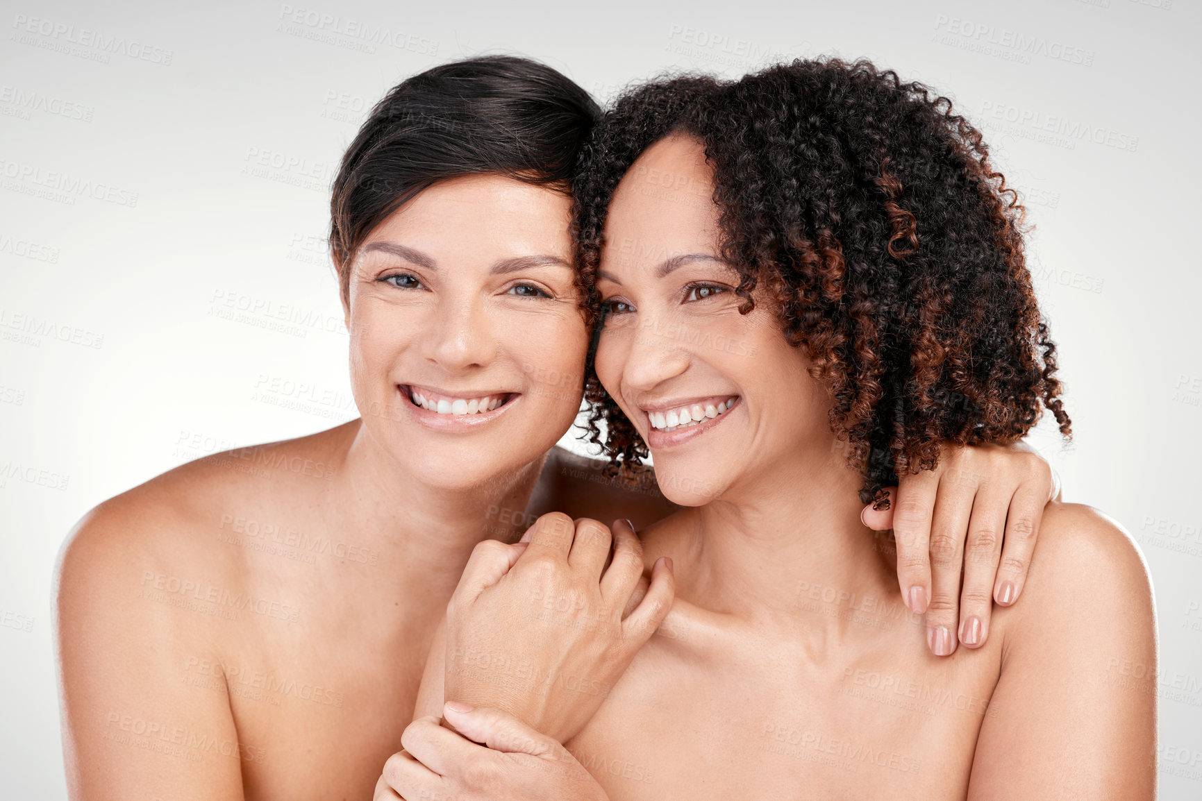 Buy stock photo Cropped shot of two beautiful mature women posing against a grey background in studio