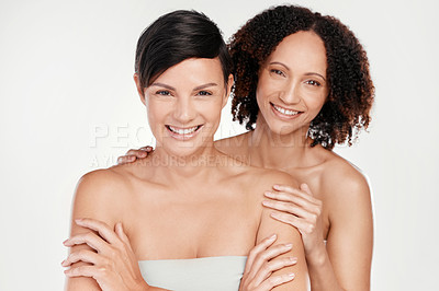 Buy stock photo Cropped portrait of two beautiful mature women posing against a grey background in studio