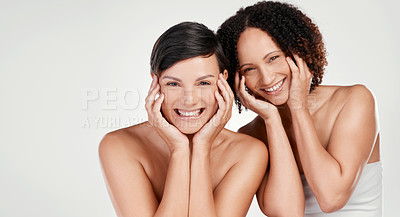 Buy stock photo Cropped portrait of two beautiful mature women posing against a grey background in studio