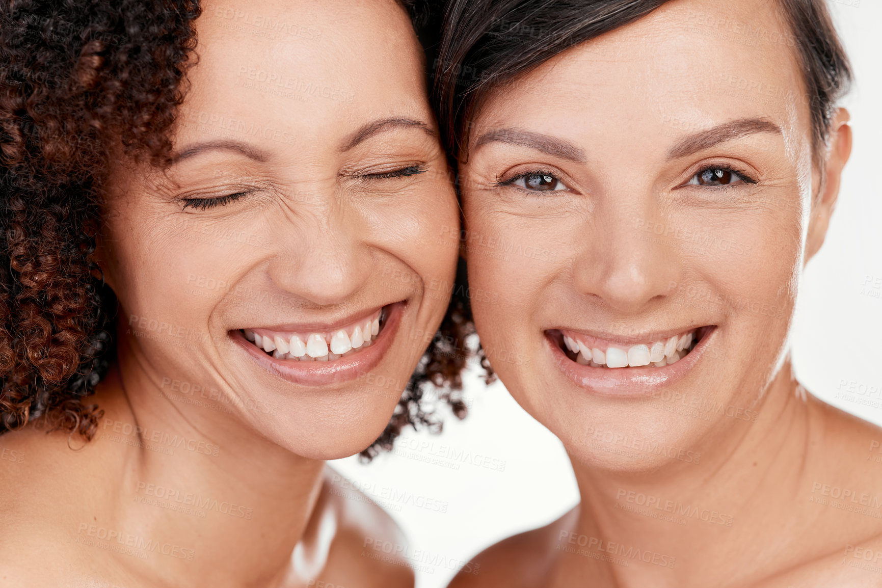 Buy stock photo Cropped shot of two beautiful mature women posing against a grey background in studio
