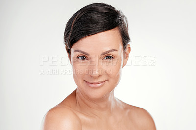 Buy stock photo Cropped portrait of a beautiful mature woman posing against a grey background in studio